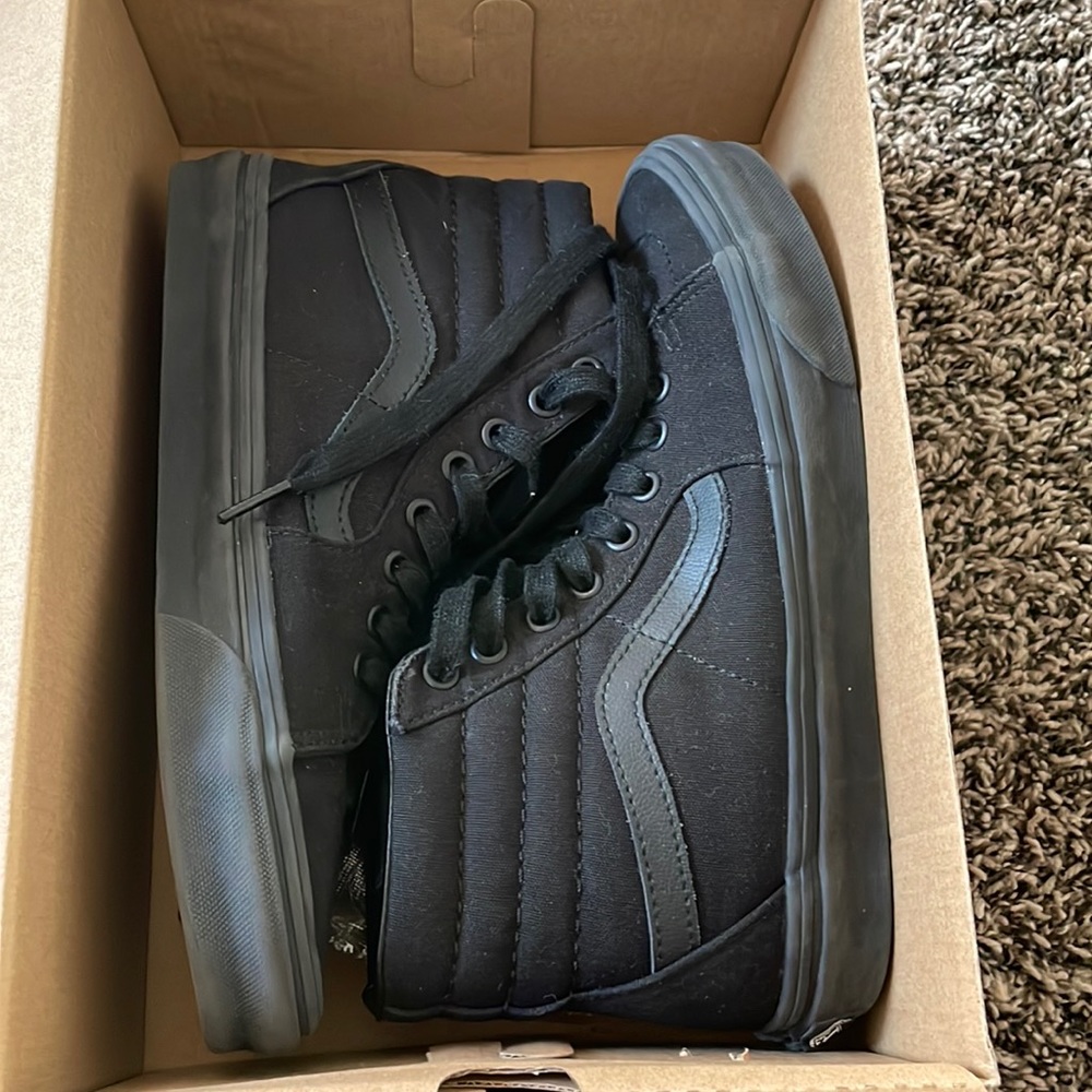 Never worn high top black vans in great condition